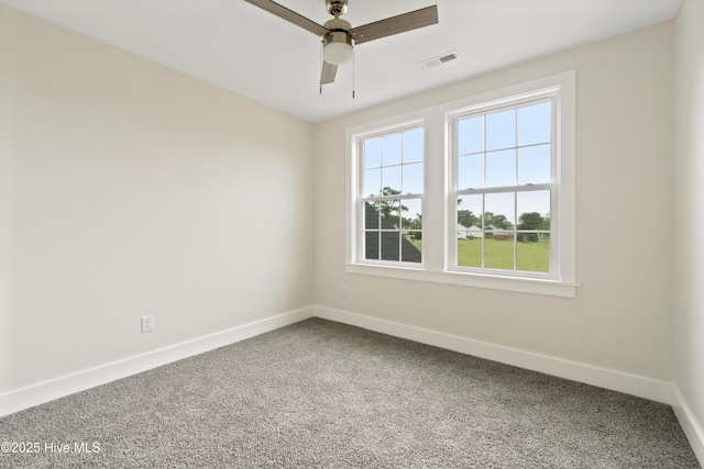 empty room featuring visible vents, carpet flooring, baseboards, and ceiling fan