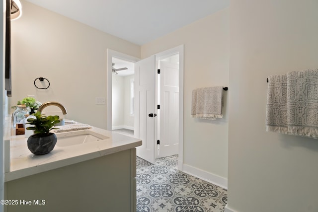 bathroom featuring baseboards and a sink