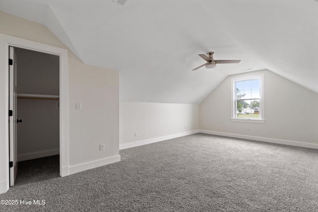 additional living space with vaulted ceiling, baseboards, carpet, and ceiling fan