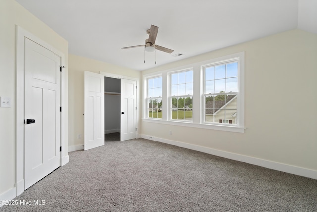 unfurnished bedroom featuring visible vents, baseboards, a closet, ceiling fan, and carpet floors
