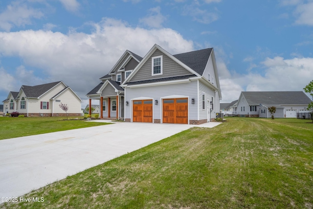 craftsman house featuring an attached garage, a front yard, and driveway