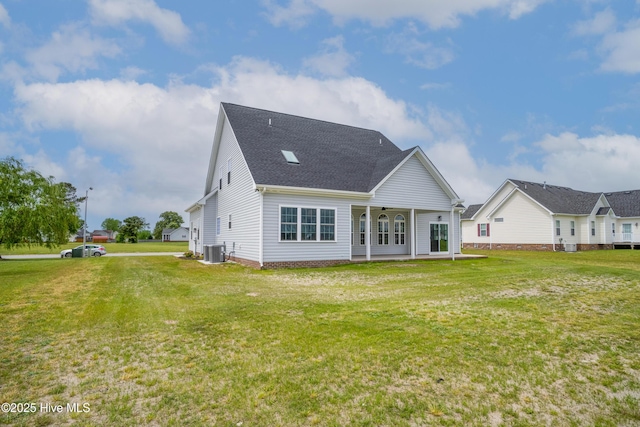 back of house featuring ceiling fan, a yard, and central AC