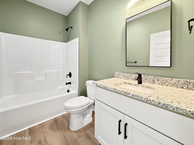 full bath with toilet, vanity, wood finished floors, and tub / shower combination