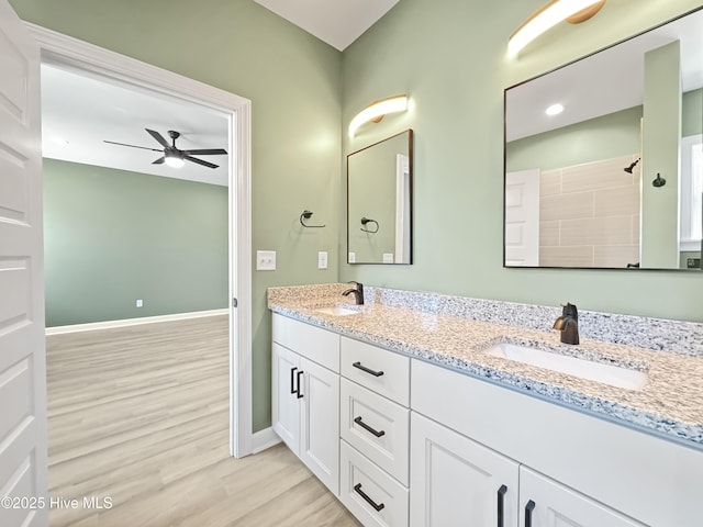 full bathroom featuring wood finished floors, baseboards, ceiling fan, and a sink