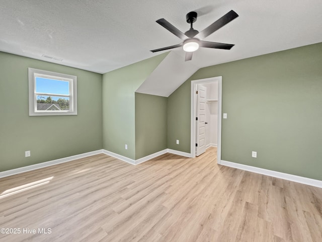 bonus room with baseboards, a ceiling fan, wood finished floors, and visible vents