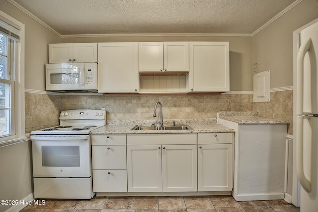 kitchen featuring a sink, a textured ceiling, white appliances, white cabinets, and light stone countertops