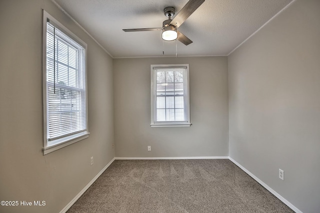 spare room featuring a ceiling fan, baseboards, carpet, and a textured ceiling