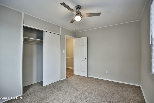 unfurnished bedroom featuring carpet floors, a closet, and baseboards