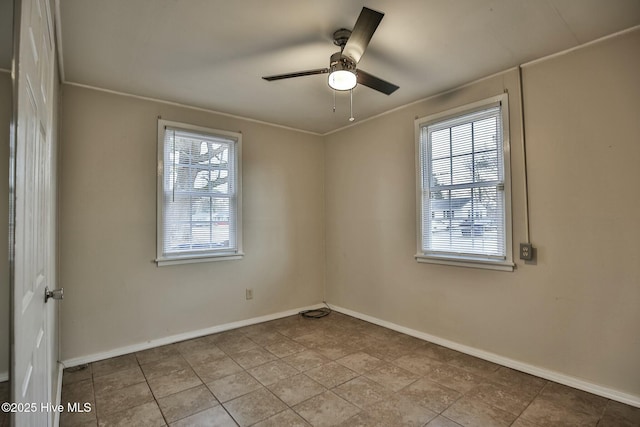 tiled spare room with baseboards and ceiling fan