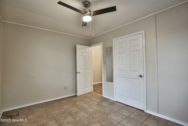 unfurnished bedroom featuring baseboards and a ceiling fan