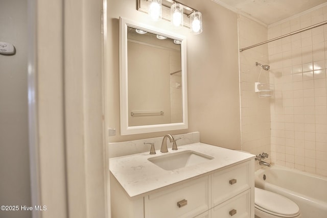 full bathroom featuring crown molding, toilet, vanity, and  shower combination