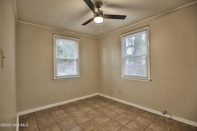 empty room featuring ceiling fan, tile patterned floors, and plenty of natural light