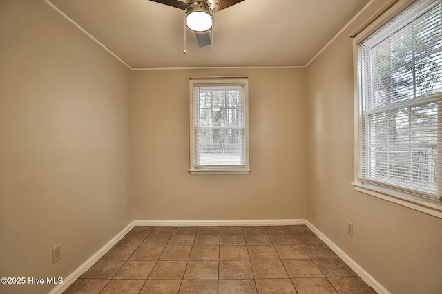 tiled empty room featuring a ceiling fan, baseboards, and ornamental molding