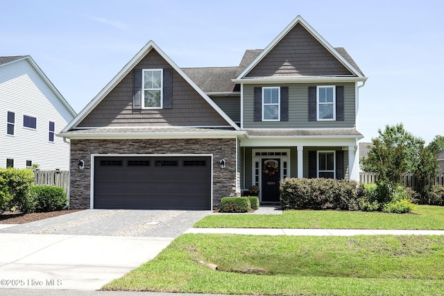 6509 Fawn Settle Dr, Wilmington, NC 28409 - craftsman house featuring driveway, stone siding, a porch, a shingled roof, and an attached garage