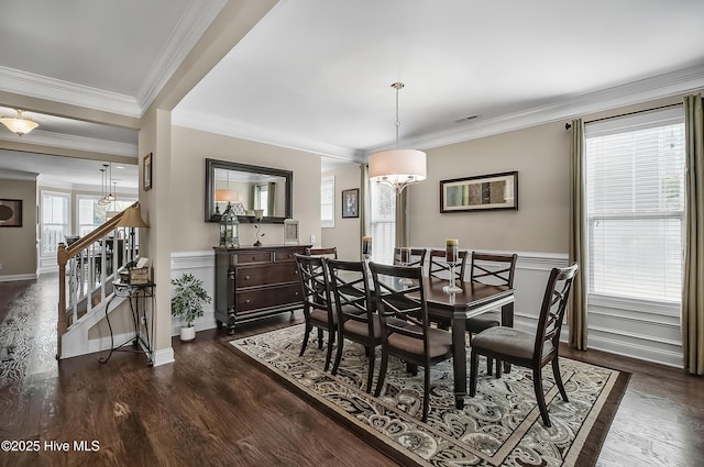 6509 Fawn Settle Dr, Wilmington, NC 28409 - dining area with dark wood-style floors, ornamental molding, stairway, and a chandelier