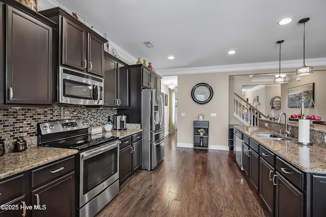 6509 Fawn Settle Dr, Wilmington, NC 28409 - kitchen featuring appliances with stainless steel finishes, ornamental molding, light stone counters, tasteful backsplash, and dark wood-style floors