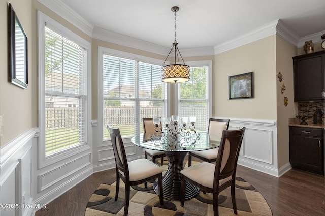 6509 Fawn Settle Dr, Wilmington, NC 28409 - dining space with dark wood-style floors, a decorative wall, wainscoting, and ornamental molding