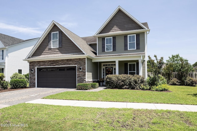 6509 Fawn Settle Dr, Wilmington, NC 28409 - view of front of house with driveway, a front yard, stone siding, a porch, and a garage