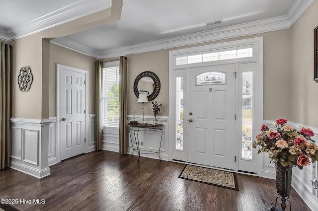 6509 Fawn Settle Dr, Wilmington, NC 28409 - foyer entrance featuring dark wood-style floors, wainscoting, crown molding, and a decorative wall