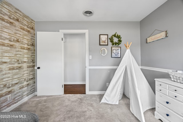 1401 W Queen St, Edenton, NC 27932 - rec room with an accent wall, visible vents, wooden walls, and carpet