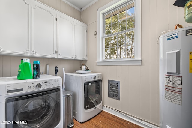 1401 W Queen St, Edenton, NC 27932 - laundry area with washing machine and clothes dryer, electric water heater, heating unit, and cabinet space