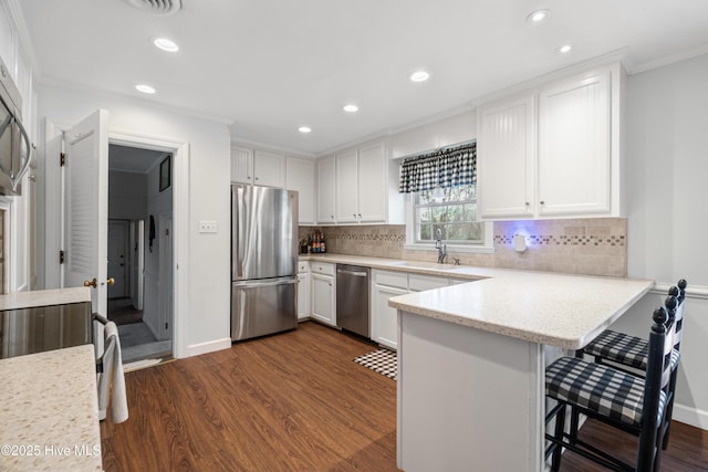 1401 W Queen St, Edenton, NC 27932 - kitchen with dark wood-style flooring, white cabinetry, stainless steel appliances, and a sink