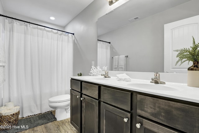 141 Beacon Woods Dr, Holly Ridge, NC 28445 - full bathroom with toilet, wood finished floors, double vanity, a shower with shower curtain, and recessed lighting