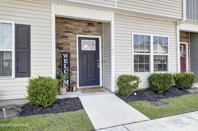 141 Beacon Woods Dr, Holly Ridge, NC 28445 - view of exterior entry featuring stone siding