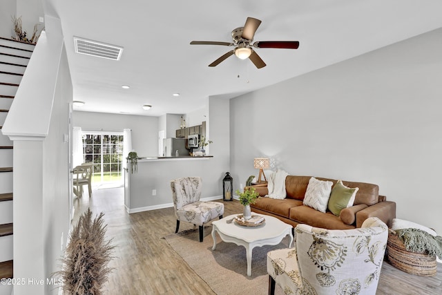 141 Beacon Woods Dr, Holly Ridge, NC 28445 - living room with wood finished floors, a ceiling fan, stairs, baseboards, and recessed lighting