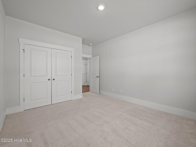 153 Ballantine Grove Ln, Newport, NC 28570 - unfurnished bedroom featuring carpet flooring, baseboards, and a closet