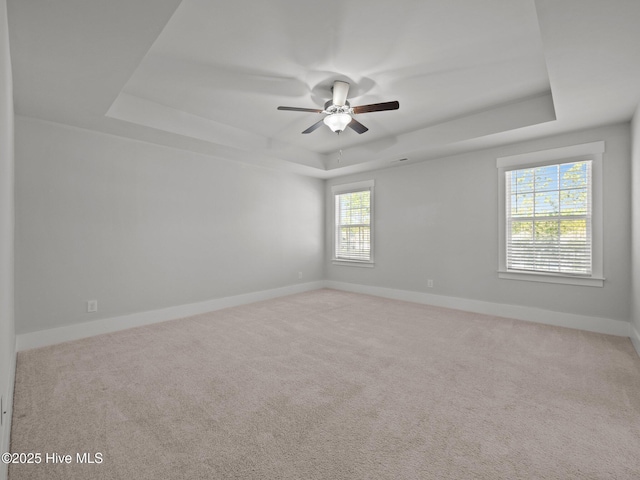 153 Ballantine Grove Ln, Newport, NC 28570 - unfurnished room with a raised ceiling, carpet, baseboards, and a ceiling fan