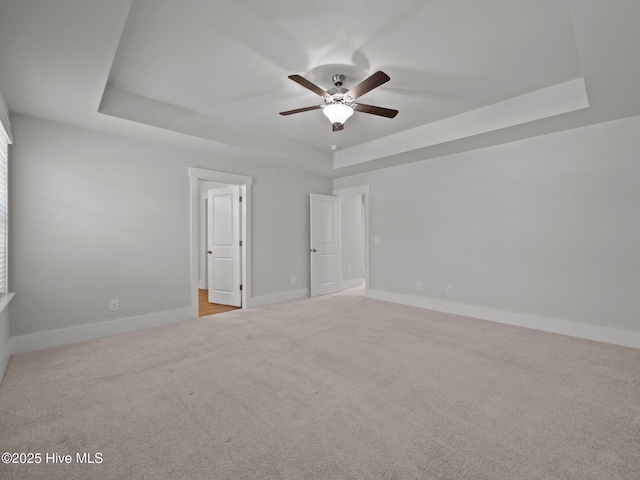 153 Ballantine Grove Ln, Newport, NC 28570 - unfurnished bedroom featuring a raised ceiling, carpet flooring, baseboards, and ceiling fan