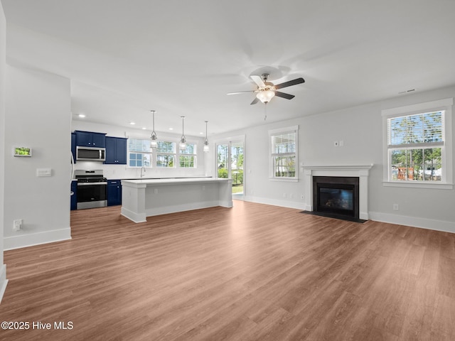 153 Ballantine Grove Ln, Newport, NC 28570 - unfurnished living room with baseboards, light wood-style floors, a ceiling fan, and recessed lighting