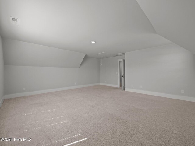 153 Ballantine Grove Ln, Newport, NC 28570 - additional living space with attic access, vaulted ceiling, carpet floors, and baseboards