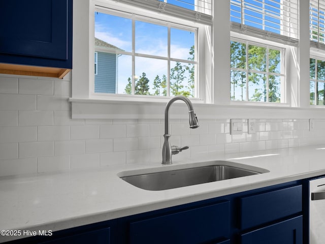 153 Ballantine Grove Ln, Newport, NC 28570 - kitchen featuring blue cabinets, a sink, backsplash, and light countertops