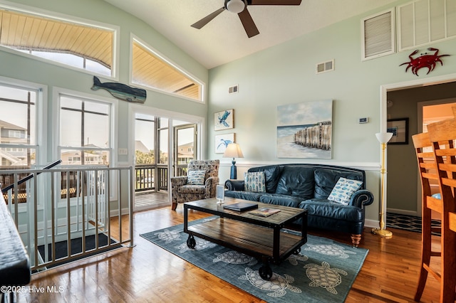 kitchen featuring a peninsula, vaulted ceiling, ceiling fan, hardwood / wood-style floors, and appliances with stainless steel finishes