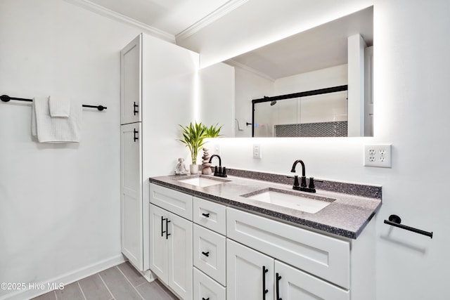 bathroom with crown molding, a stall shower, double vanity, wood finished floors, and baseboards