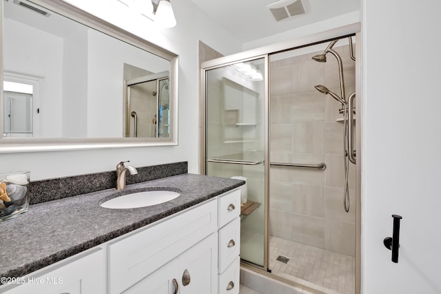 bathroom featuring a stall shower and vanity