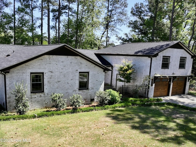 view of property exterior featuring brick siding, a garage, a shingled roof, and driveway