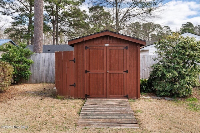 view of shed featuring fence