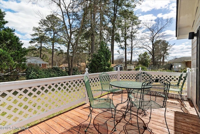 wooden terrace featuring outdoor dining space