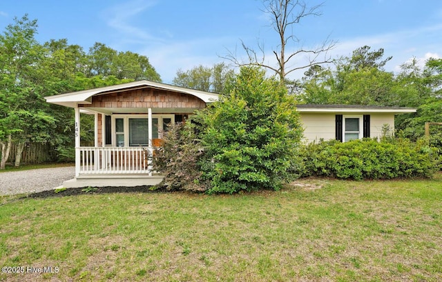 view of front of home with covered porch and a front lawn