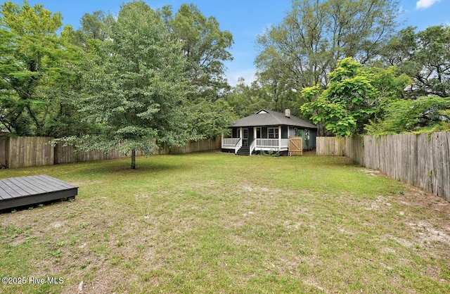 view of yard featuring a wooden deck and a porch