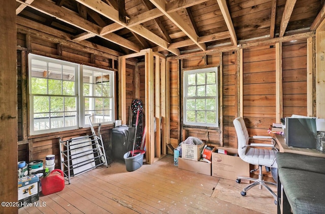 misc room featuring wood walls, an office area, and hardwood / wood-style floors
