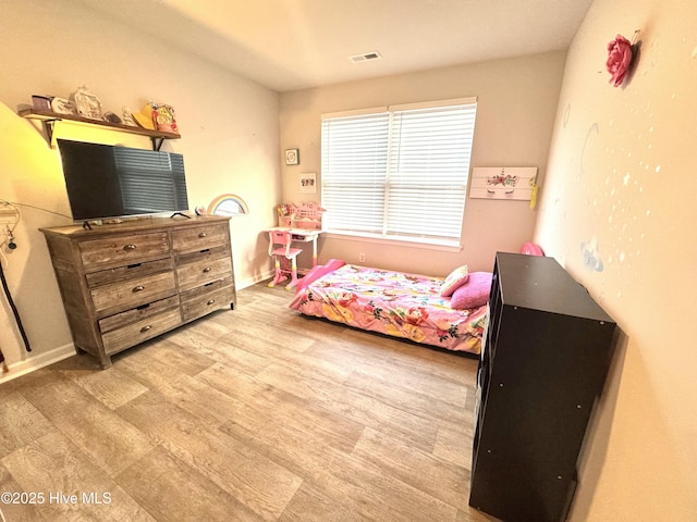bedroom featuring visible vents and light wood-type flooring