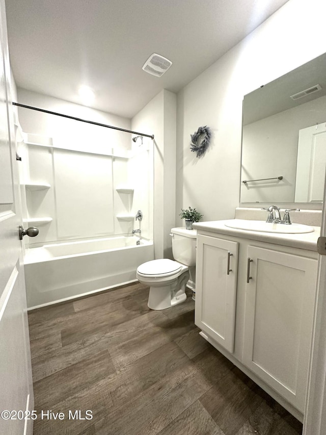 full bath with toilet, vanity, shower / bath combination, and visible vents