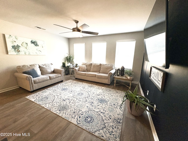 living room with ceiling fan, baseboards, wood finished floors, and visible vents