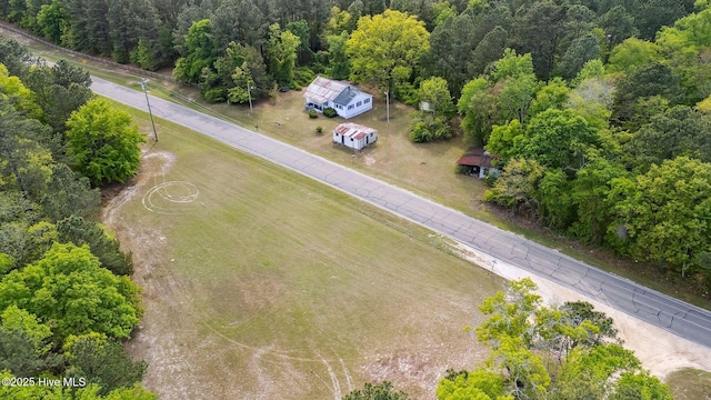 birds eye view of property with a forest view
