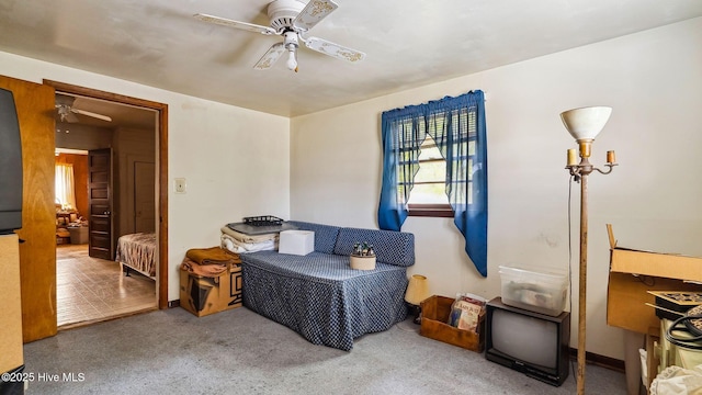 sitting room featuring ceiling fan and carpet