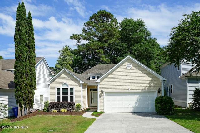 view of front of home featuring concrete driveway, a garage, and a front yard